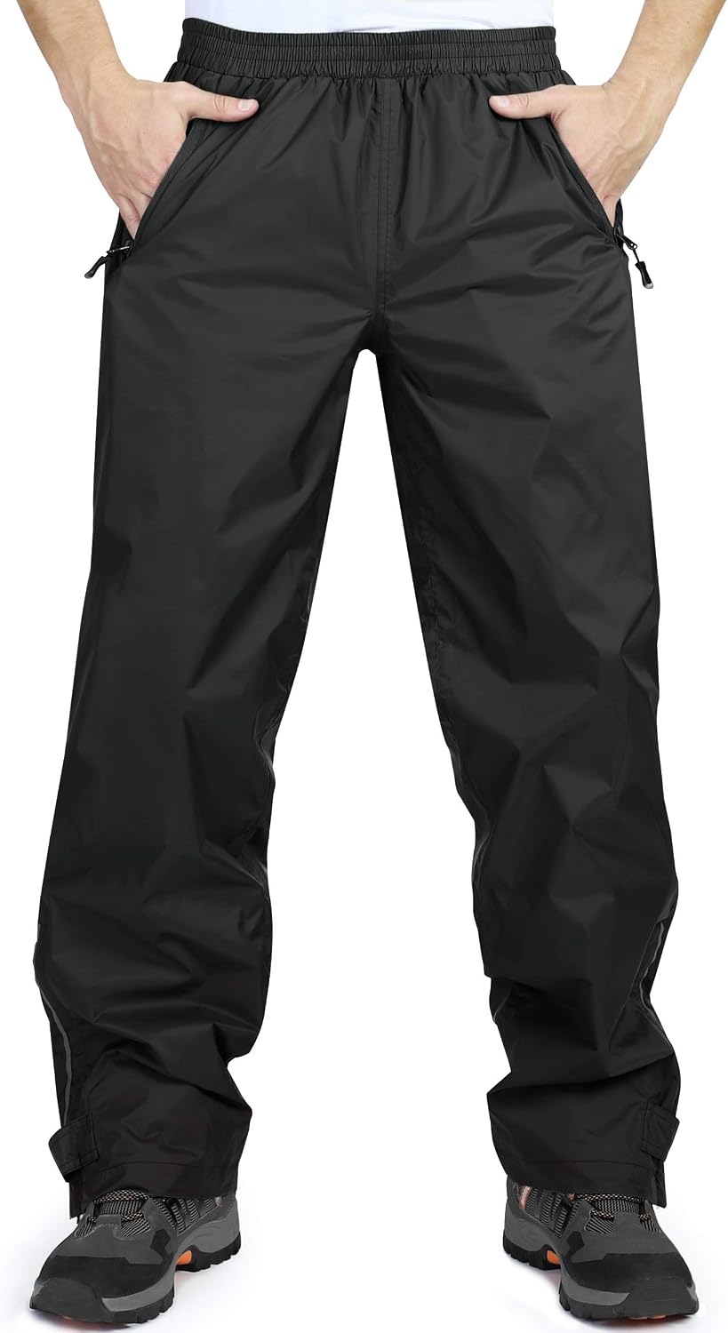 33,000ft men's black waterproof over trousers worn with hiking boots, front view