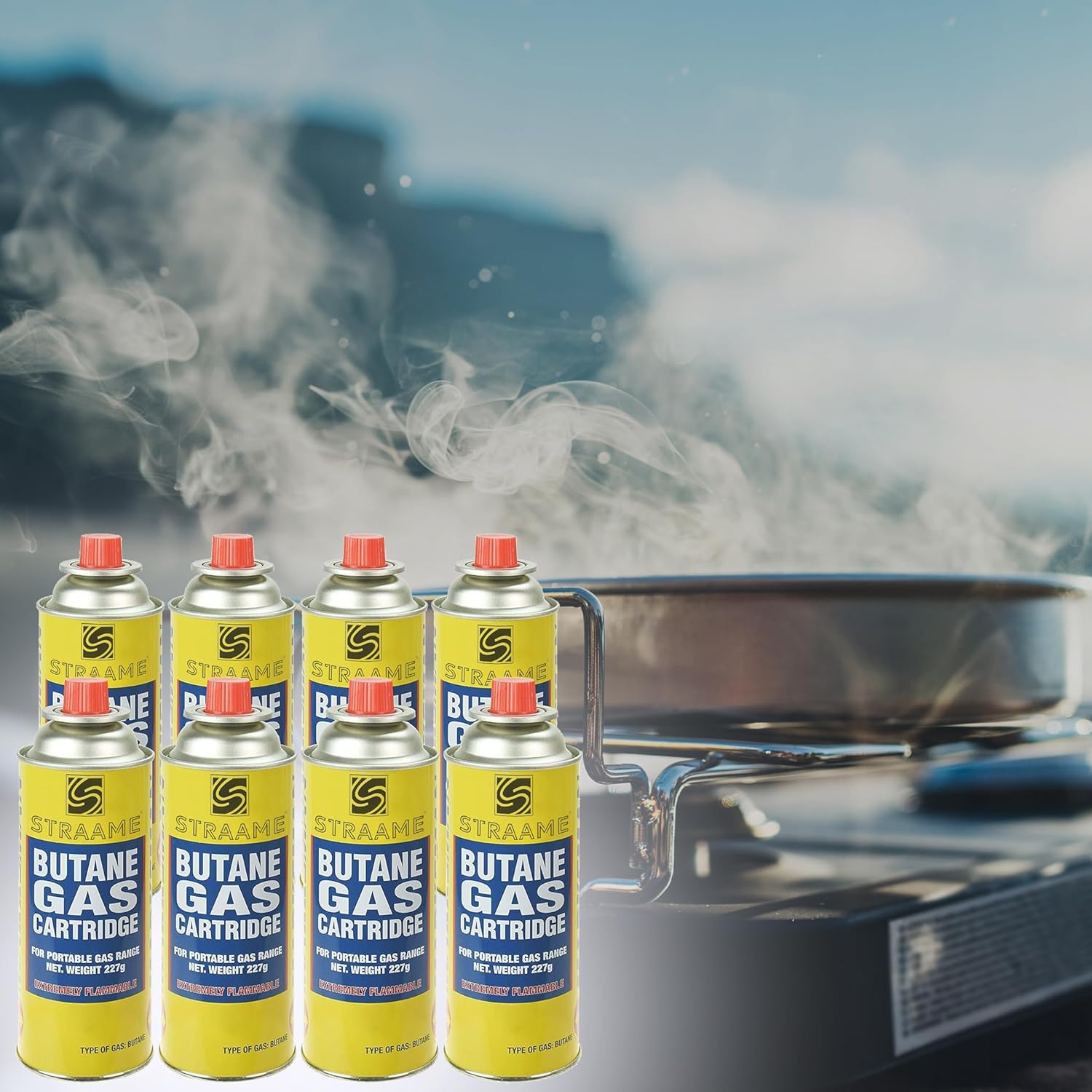 Eight Straame butane cartridges beside a camping stove with steam rising from a pan