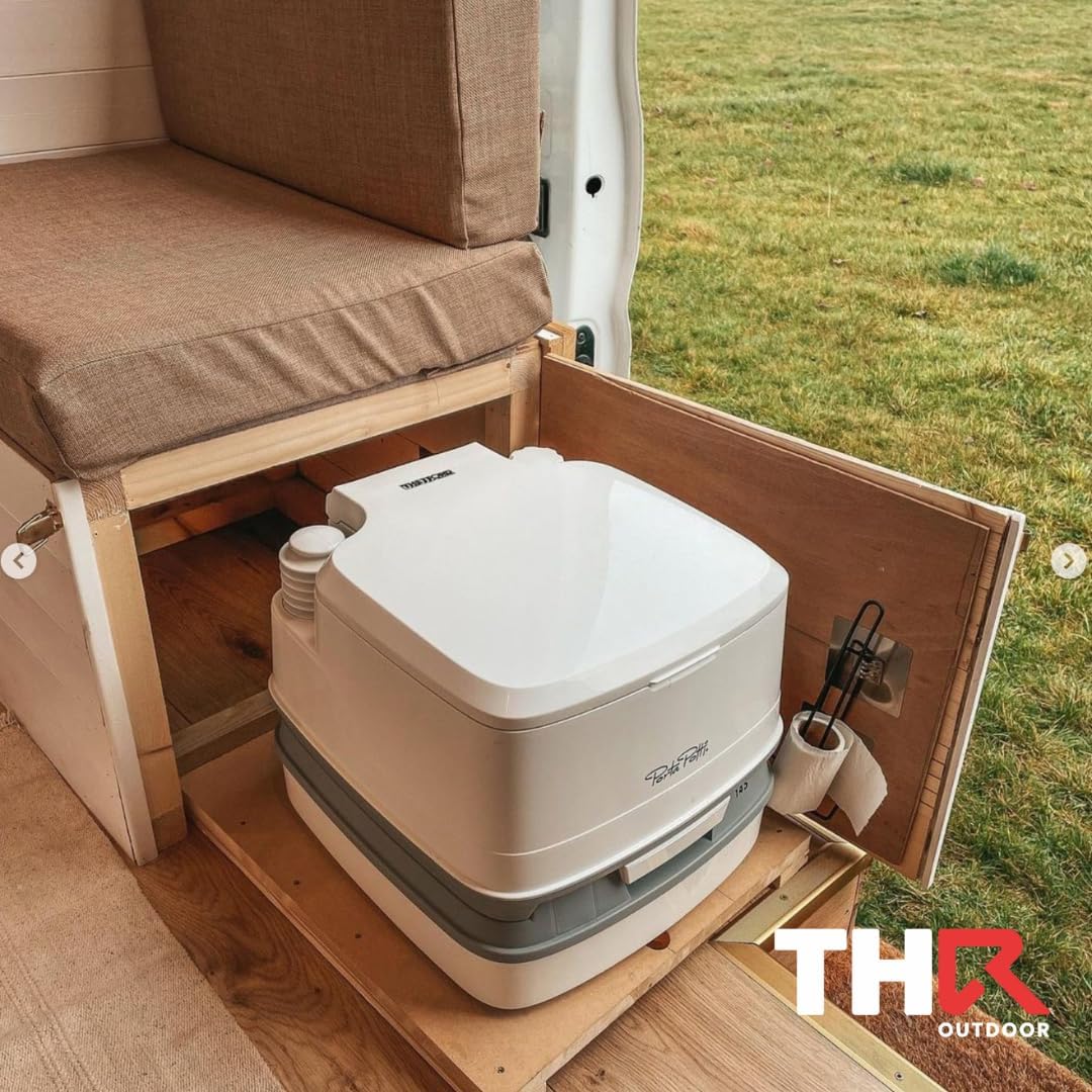 Thetford Porta Potti installed in a wooden cabinet under a campervan bench seat with a toilet roll holder