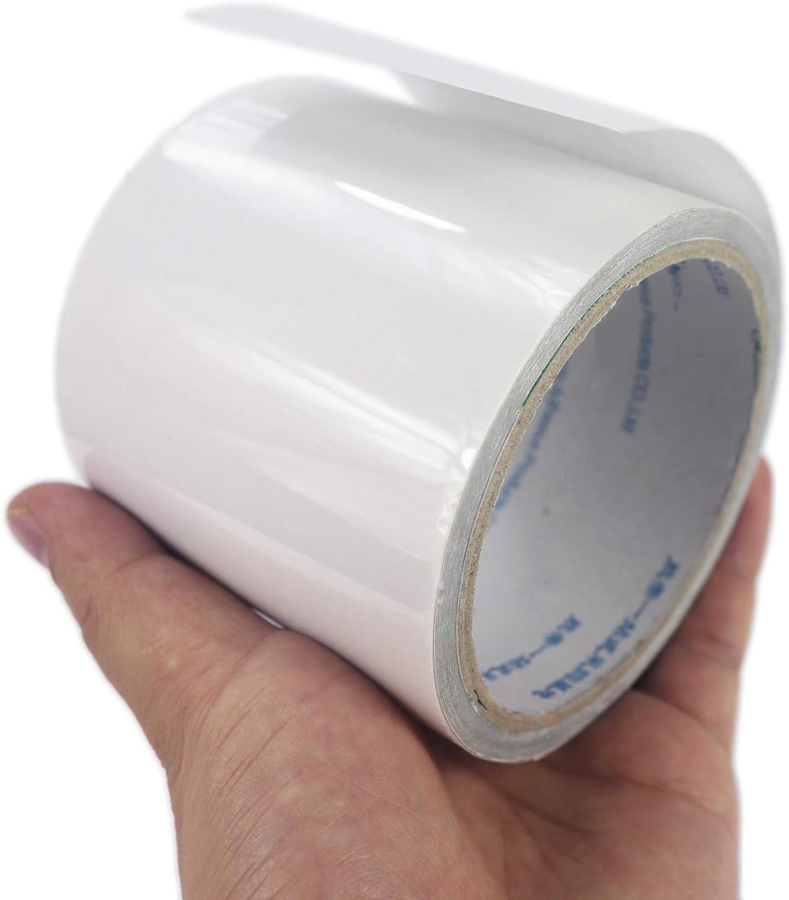 The 8cm wide LANUCN repair tape roll held in one hand for scale
