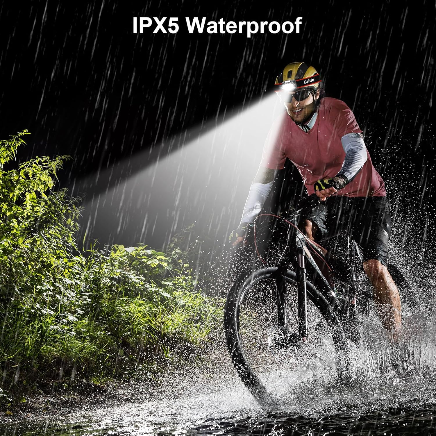 Cyclist riding through heavy rain at night wearing the Gritin head torch, demonstrating water resistance