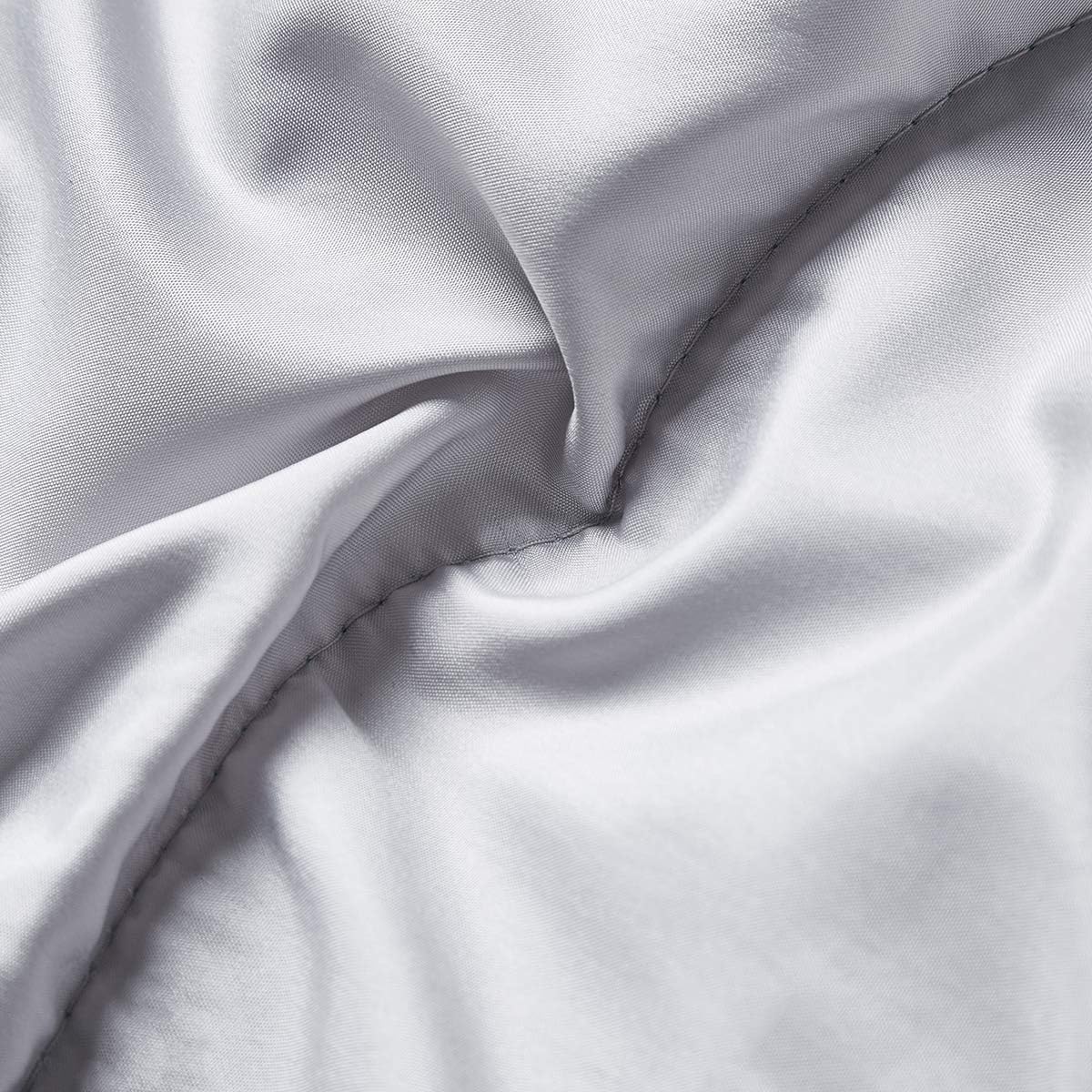Coolzon sleeping bag rolled up next to its compression sack and storage straps