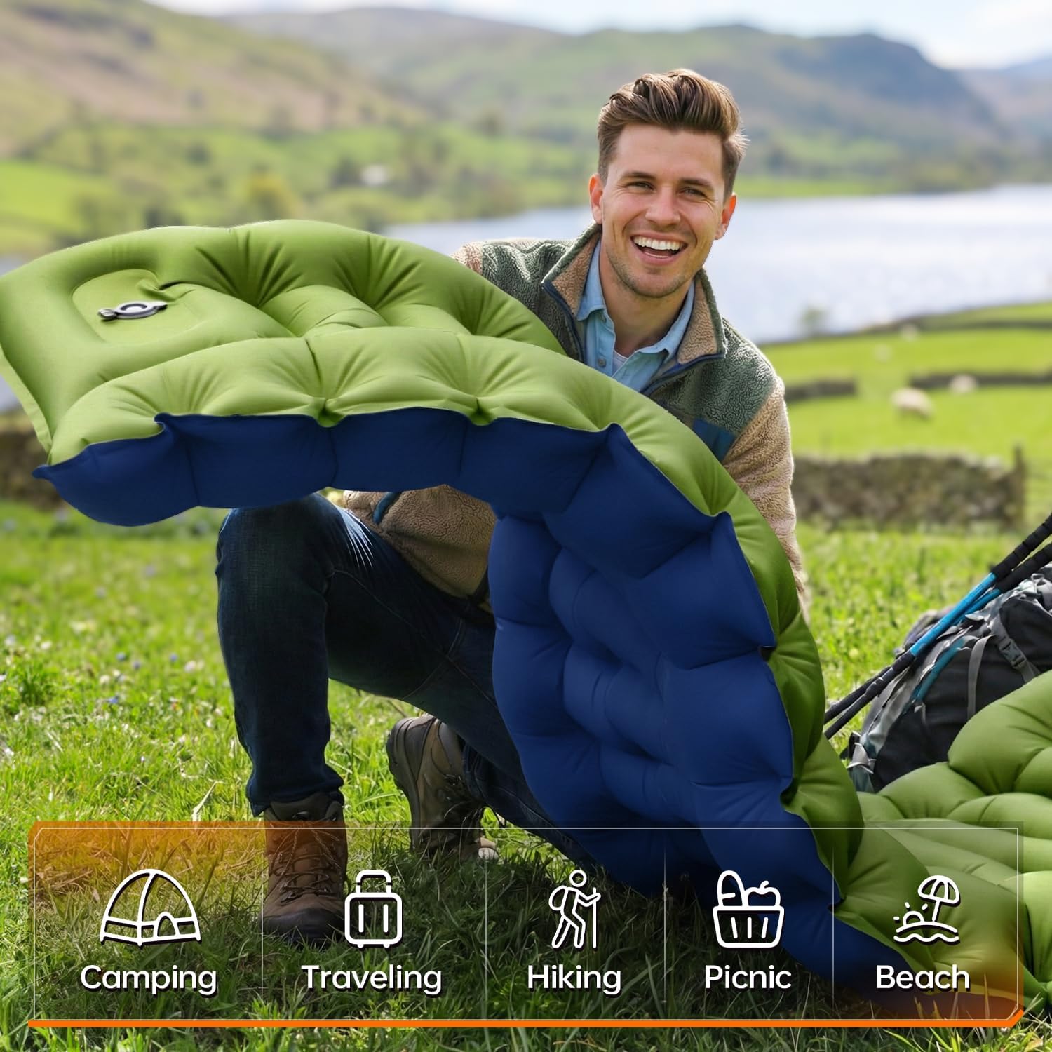 Man crouching on a Lake District hillside holding the rolled Yuzonc mat, with camping, travelling, hiking, picnic and beach use-case icons