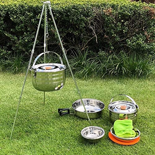 CAMPINGMOON pot hanging from a tripod over a campfire with the rest of the set arranged on the grass