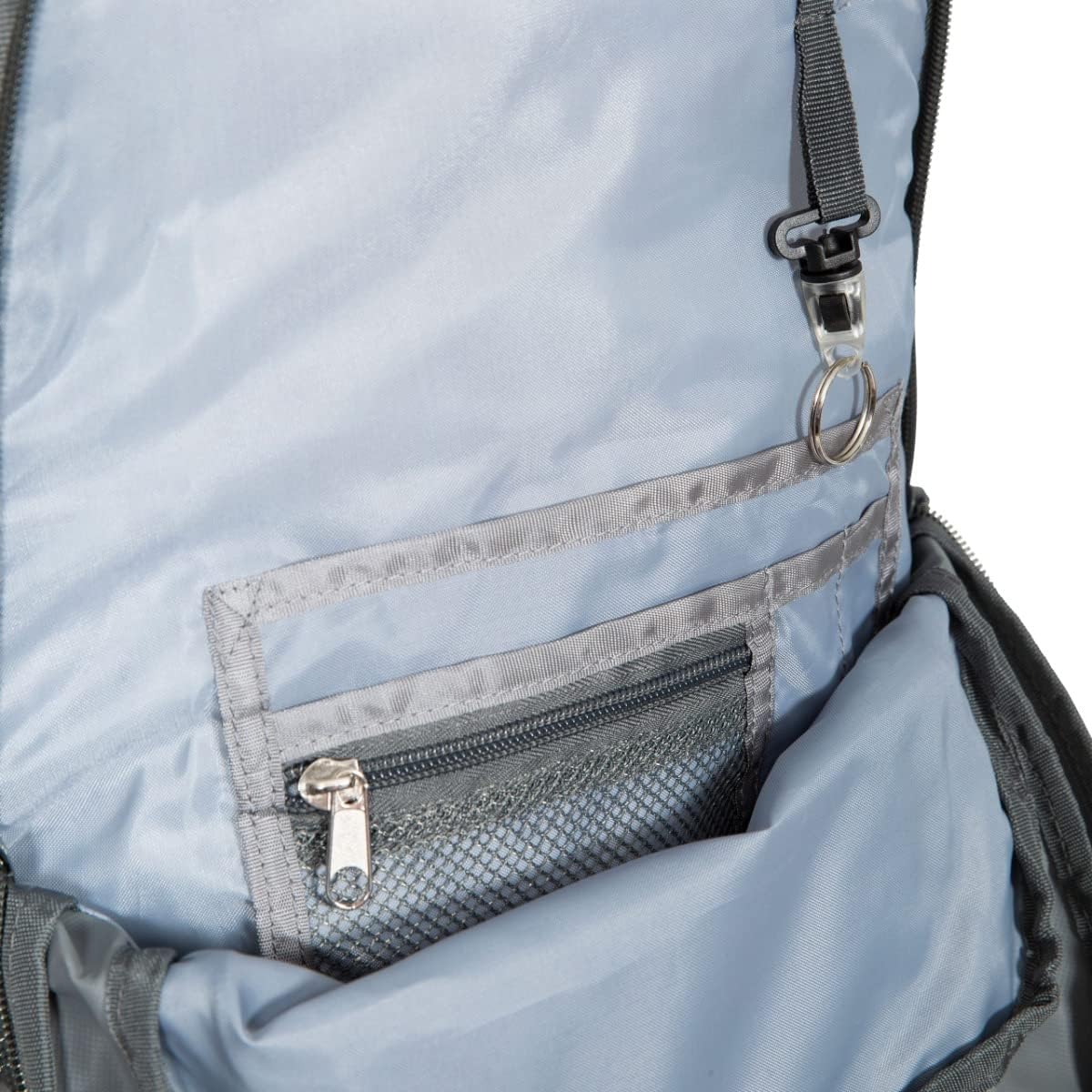 Interior of Trespass Albus backpack showing zipped mesh pocket, key clip and grey lining