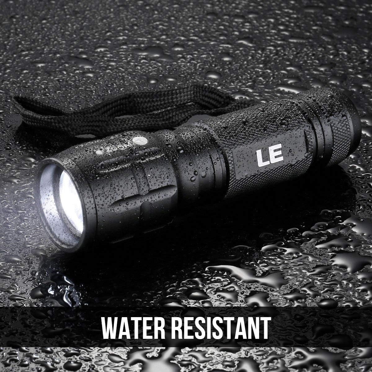 The LE torch lying on a wet surface covered in water droplets under a water resistant caption