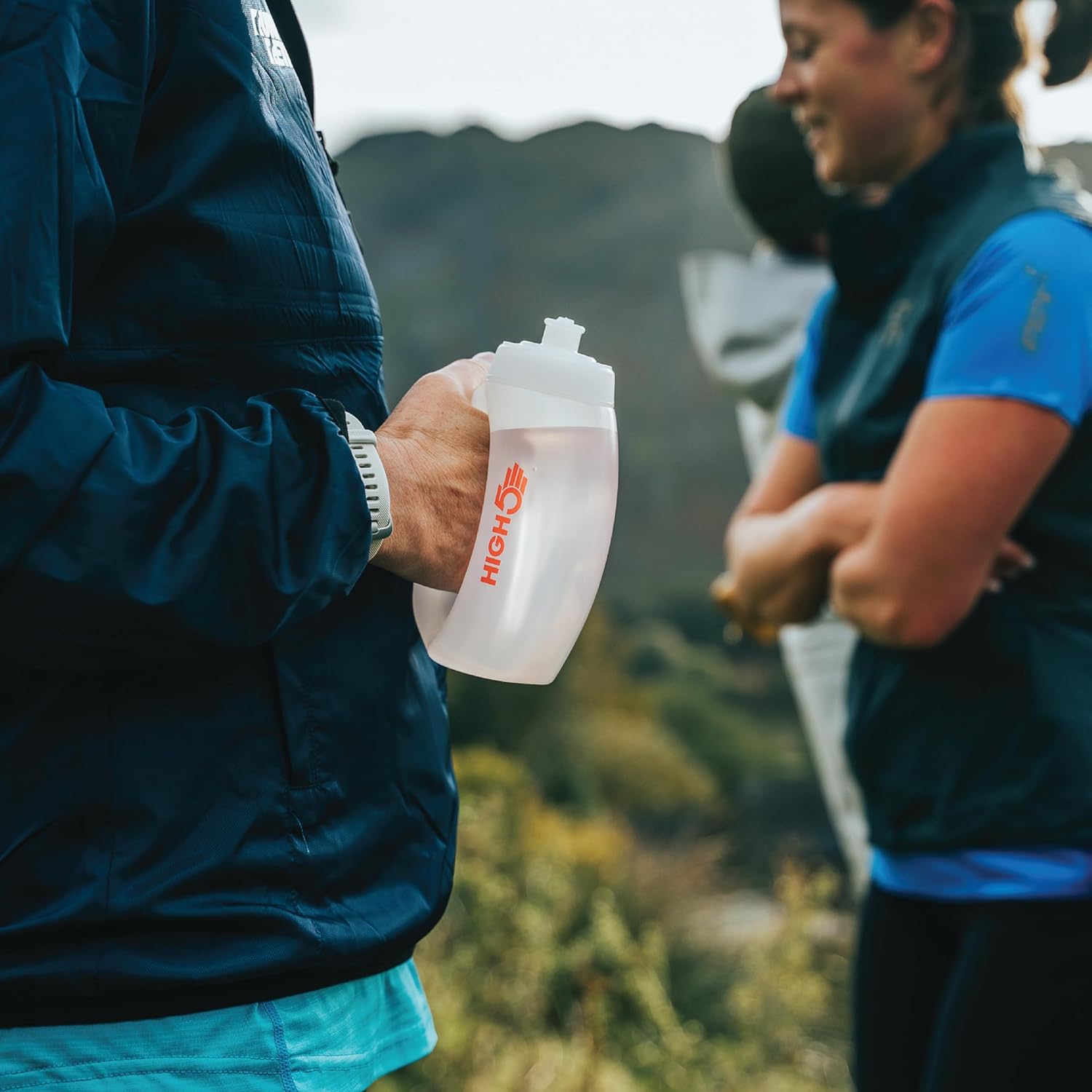 HIGH5 350ml running bottle held by its handle during a short run