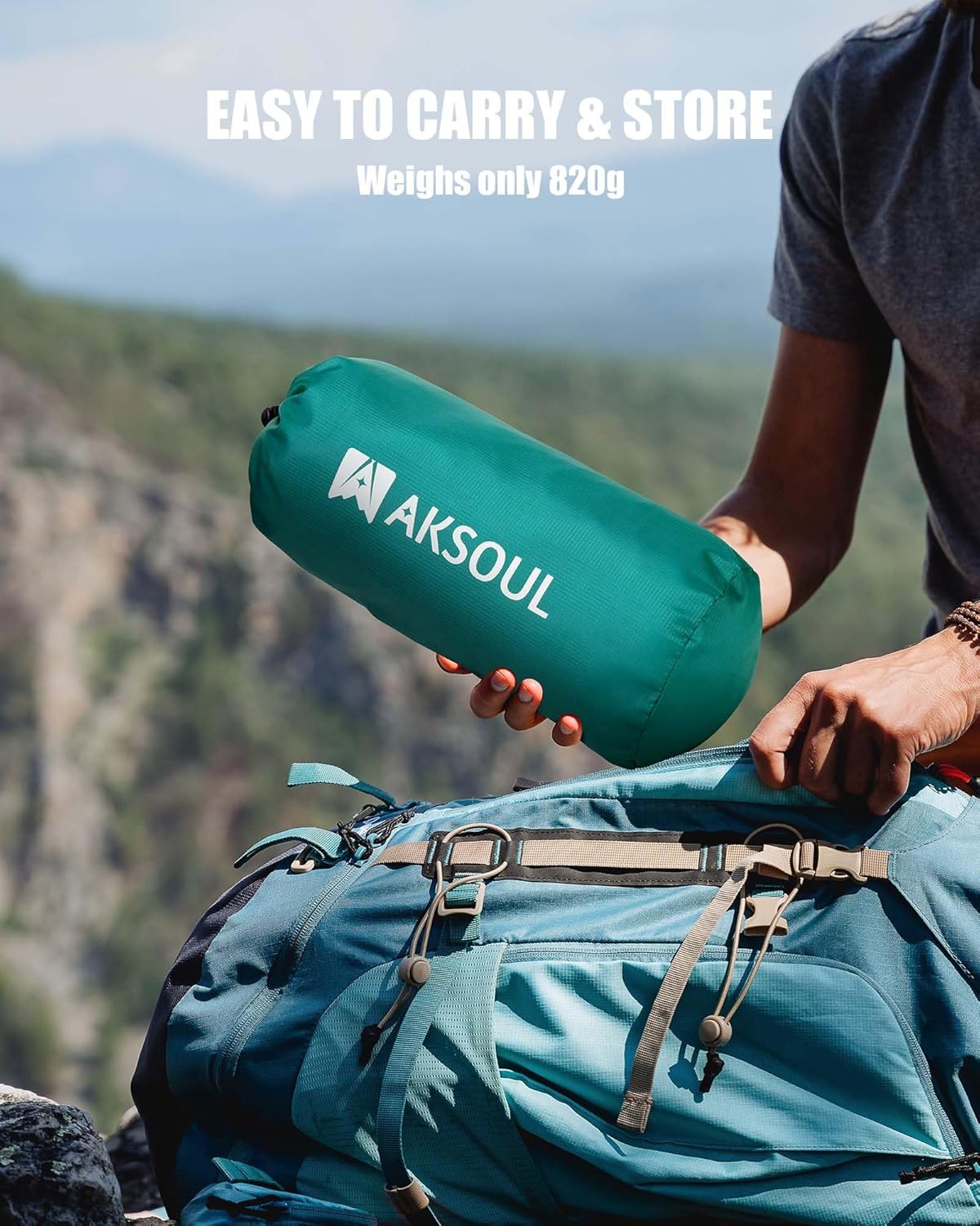 AKSOUL mat packed into its green drawstring sack being loaded into a hiking rucksack