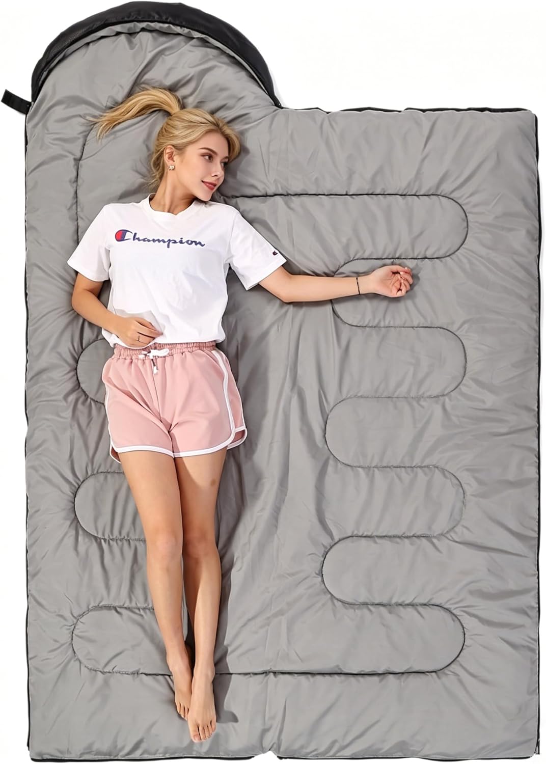 SWTMERRY sleeping bag fully unzipped and opened flat showing the grey lining, used as a duvet-style blanket