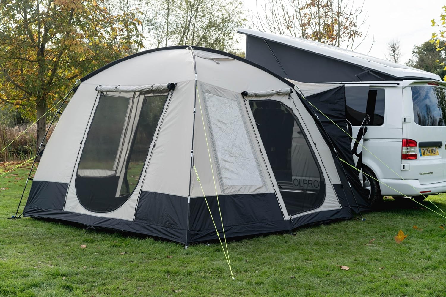 OLPRO Cubo V2 zipped shut and pitched against a white VW T5 pop-top, guy lines pegged out on grass