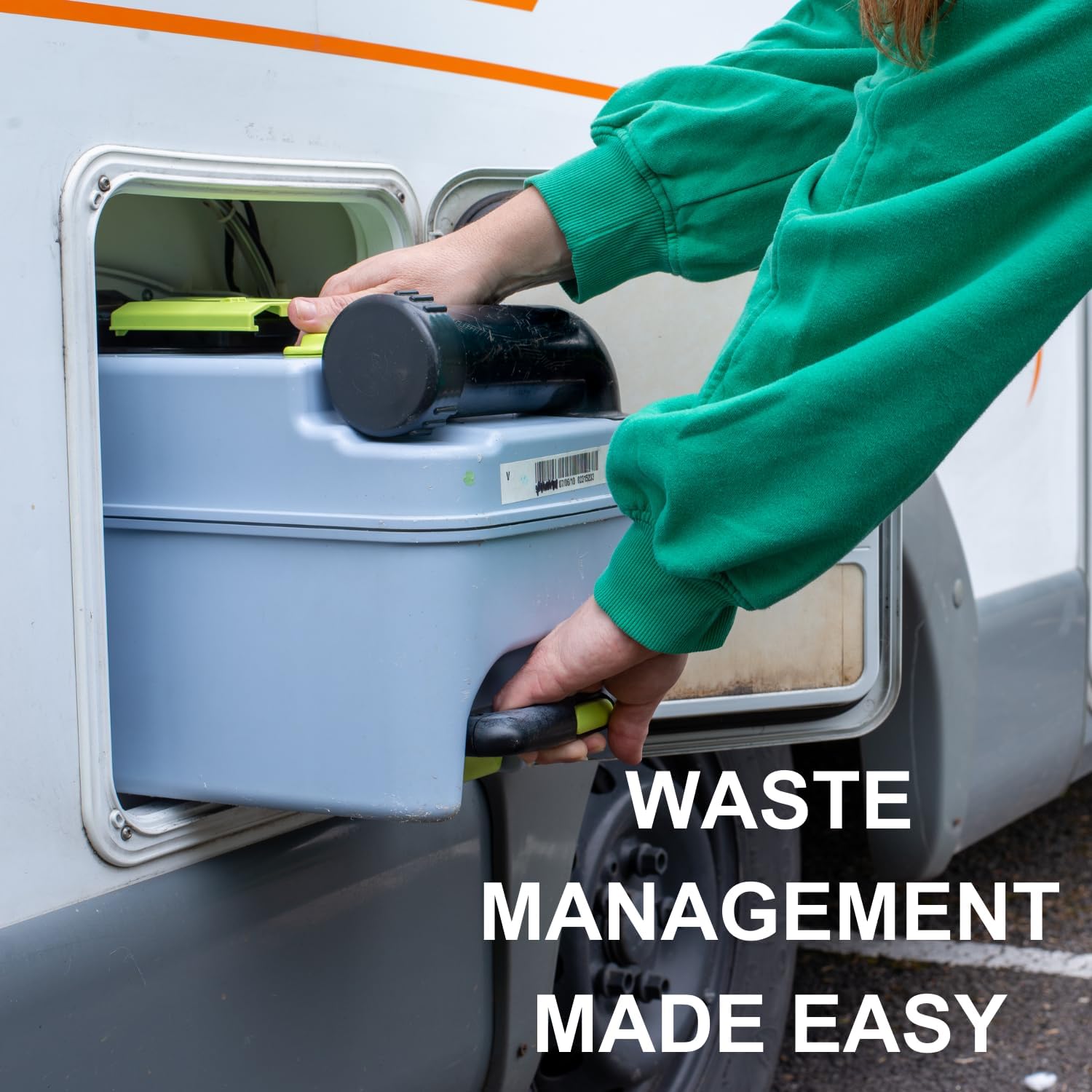 Camper pulling a waste cassette out of the external service hatch of a motorhome