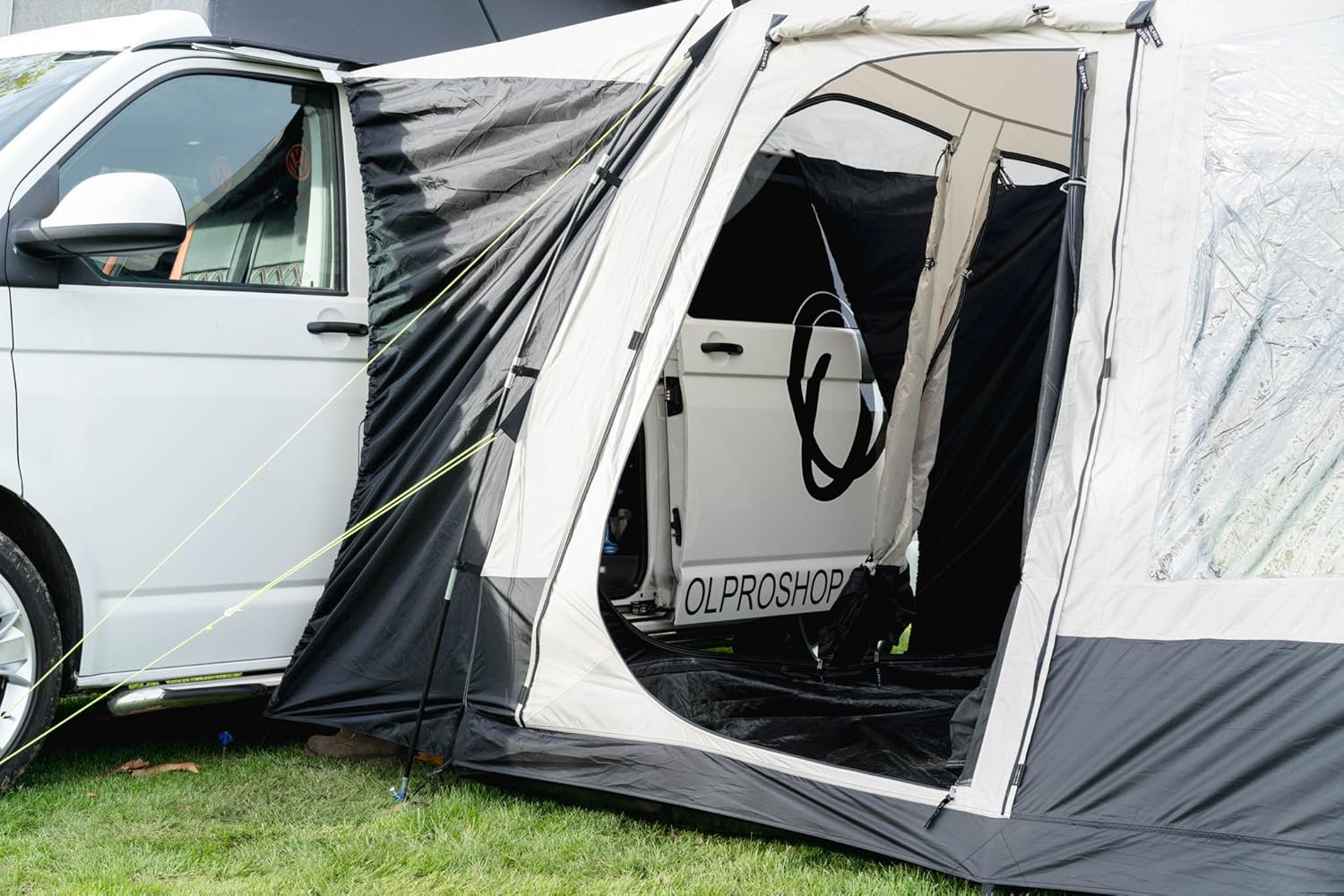 The Cubo V2 tunnel draped over the side door opening of a white campervan, showing how the sleeve meets the van
