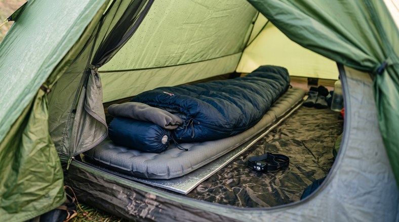 Three-season sleeping bag on an inflatable mat with a foam underlay inside a tent, the DofE Bronze sleeping kit setup
