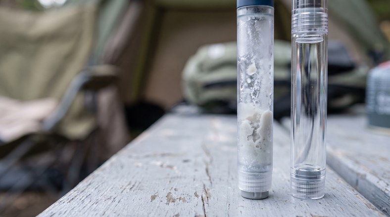 Comparing a clear insulin pen with a frosted, cloudy pen ruined by freezing when trying to keep insulin cool while camping